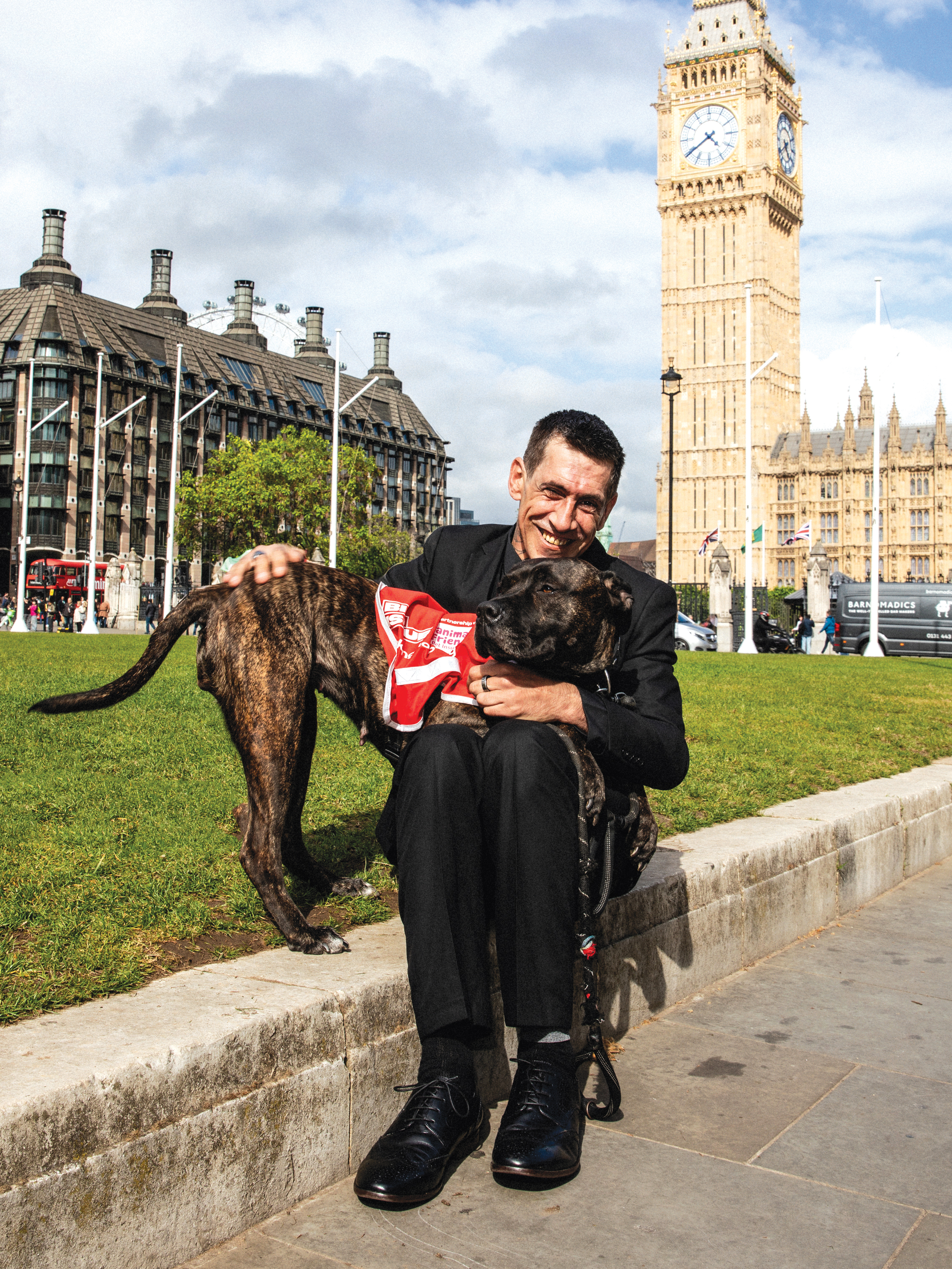 Big Issue vendor Andy Sanguy with his dog Lucky Charm outside parliament