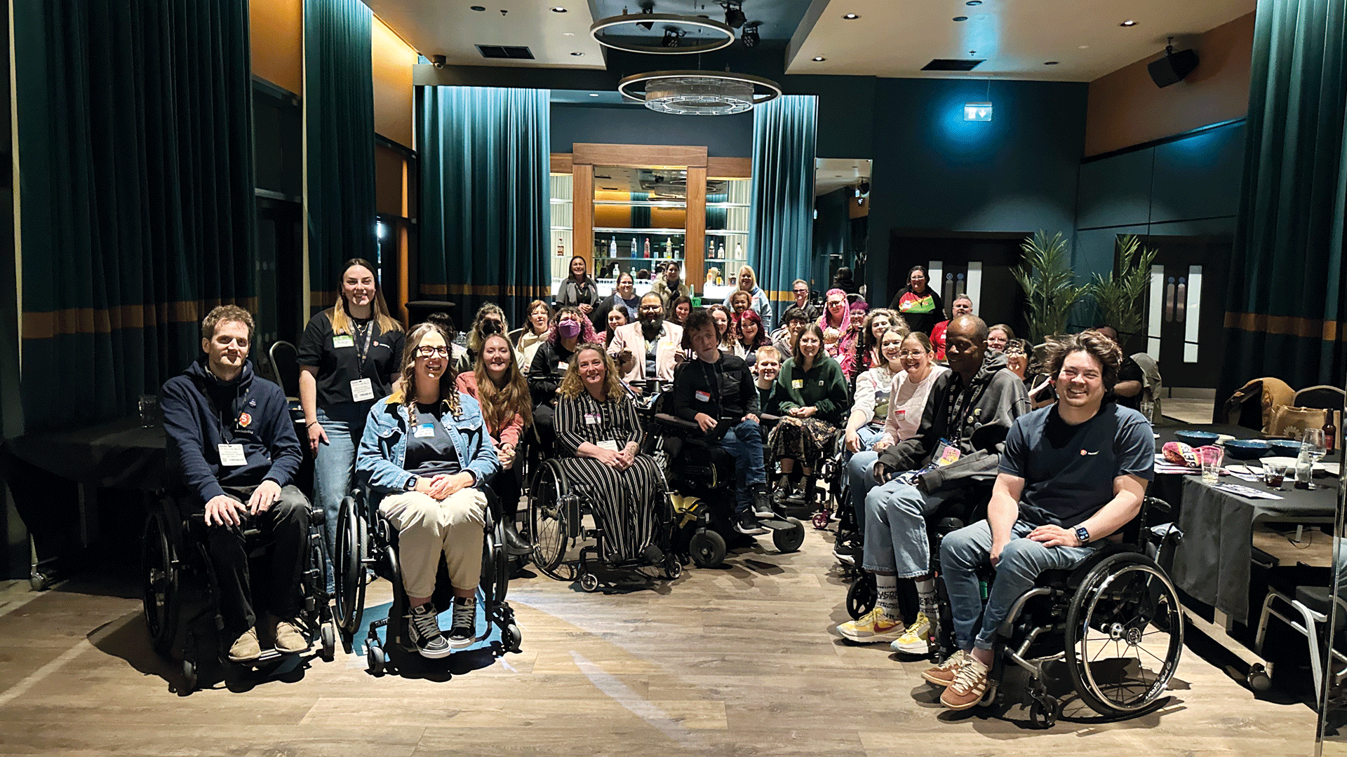 People in wheelchairs at a post-Naidex social event organised by Sociability