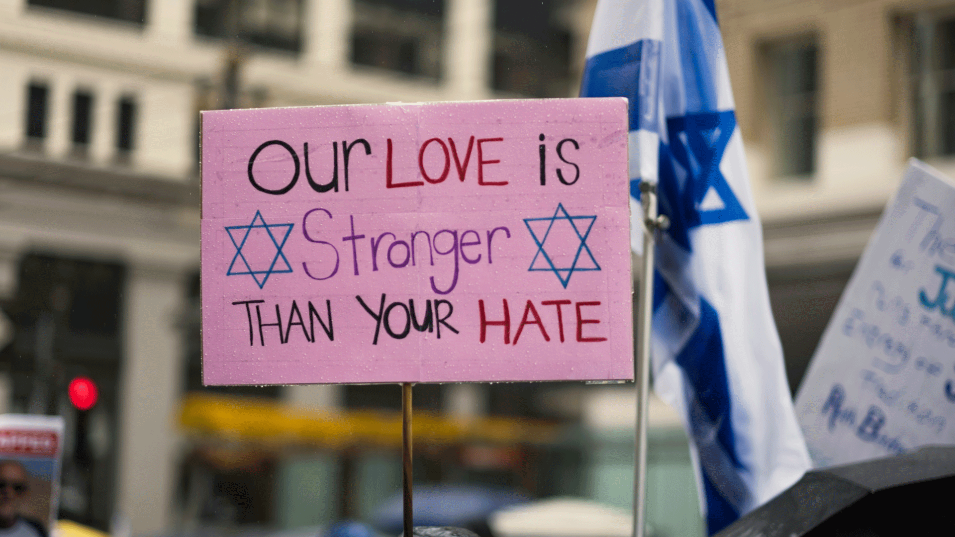A placard reading 'Our love is stronger than hate'