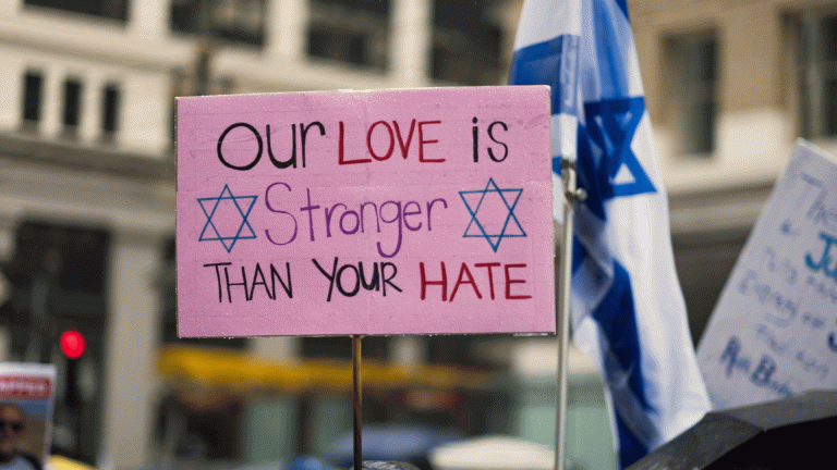 A placard reading 'Our love is stronger than hate'