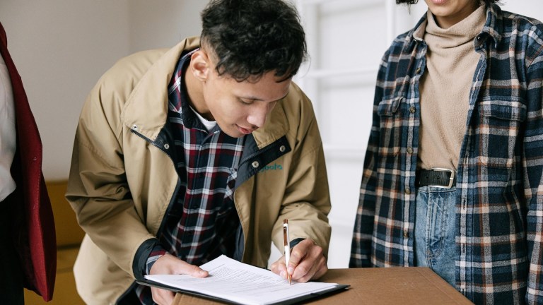 A renter signing a contract