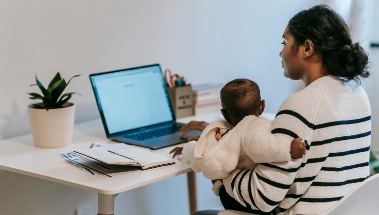 Woman with baby on computer
