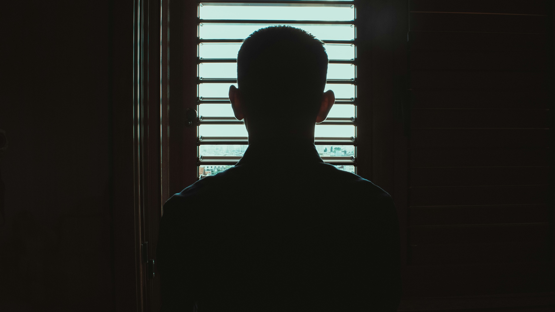 the silhouette of a young person in a home
