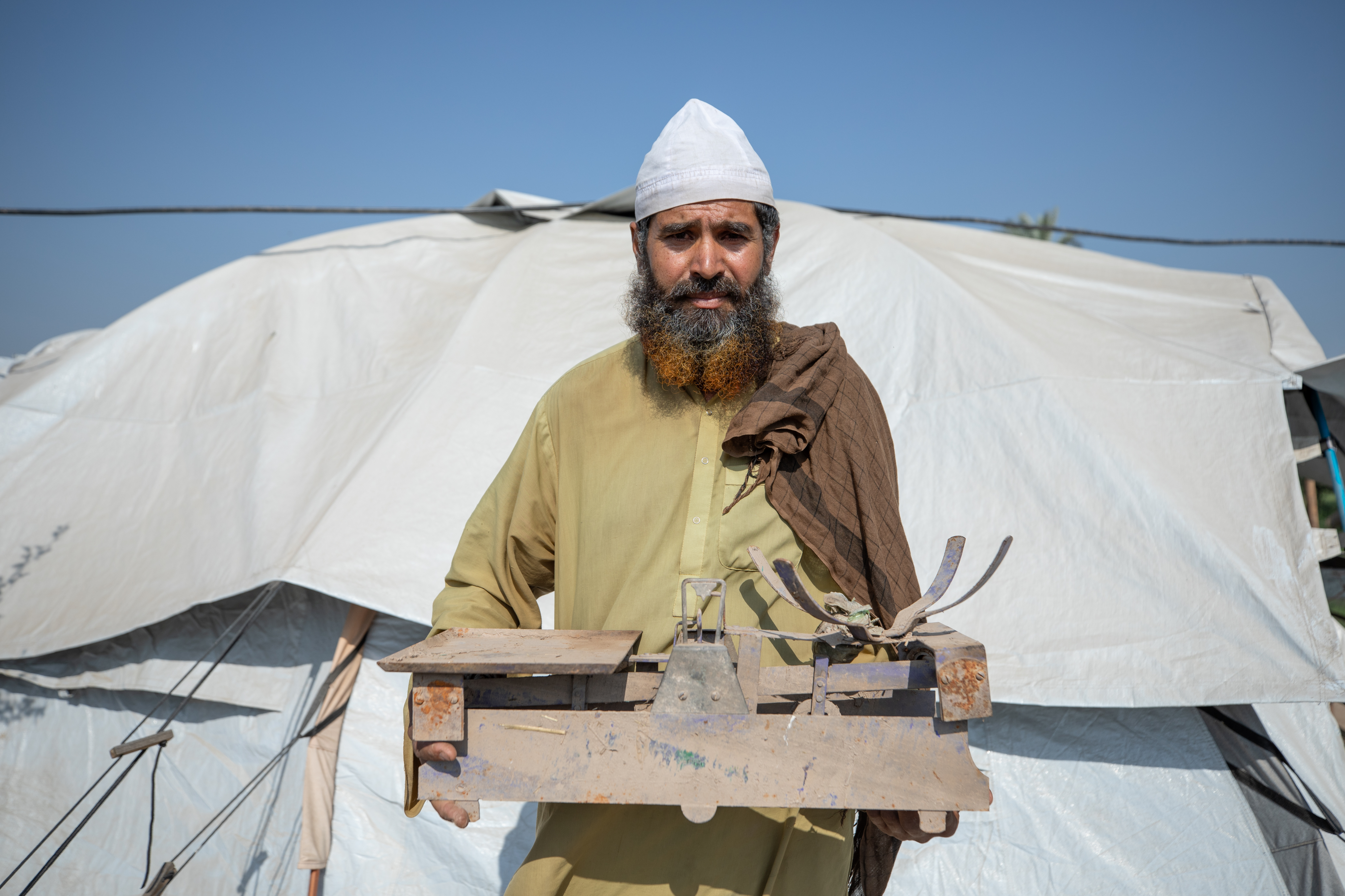 A Pakistan farmer with ruined equipment