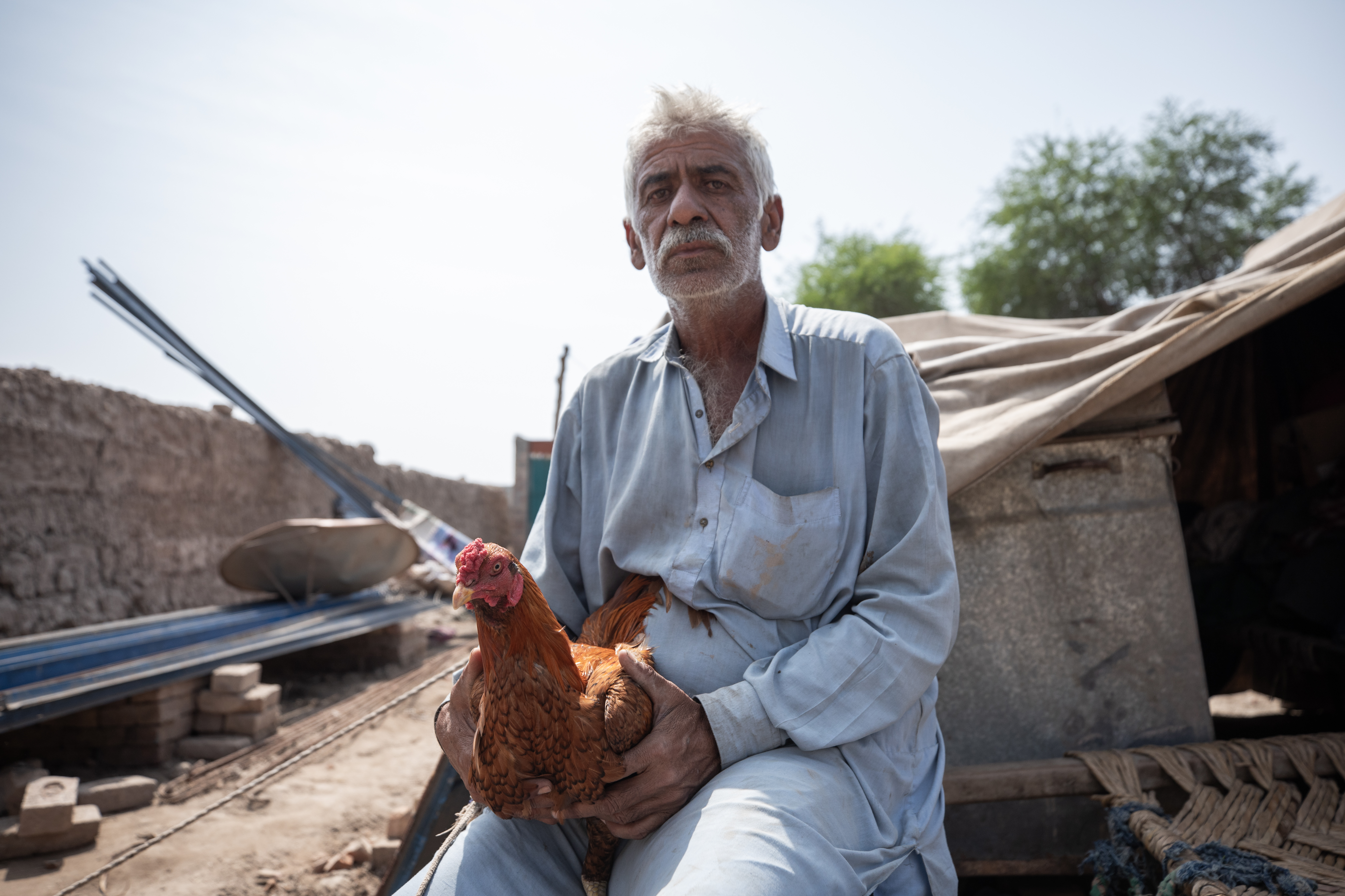 A farmer in {unjab with his chicken