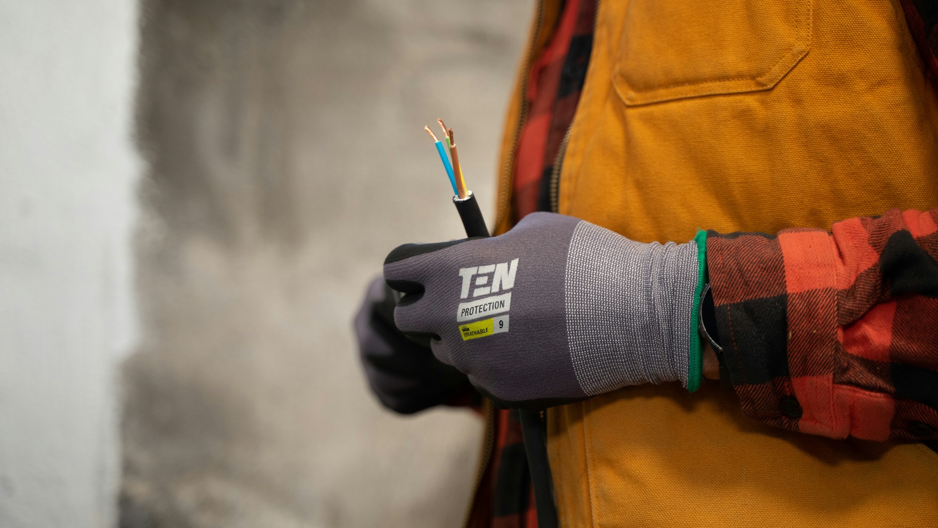 An electrician holding cut wires