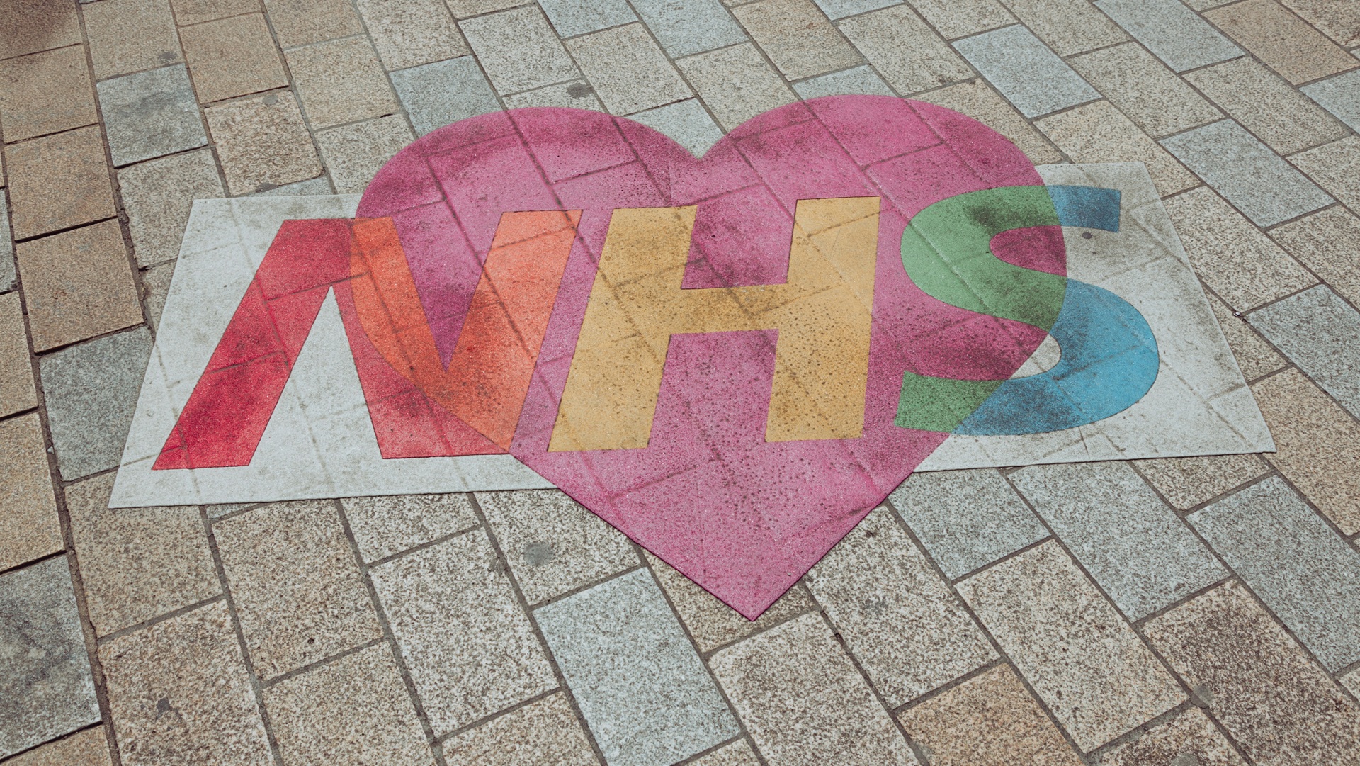 An NHS mural on a pavement