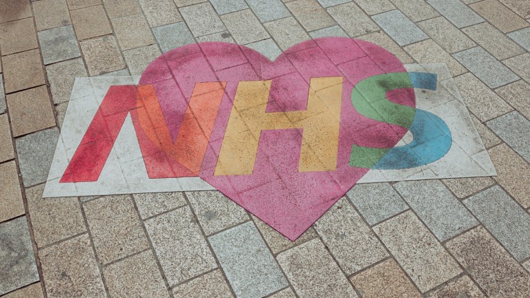 An NHS mural on a pavement