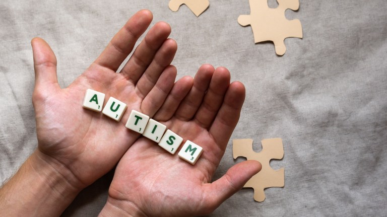Scrabble pieces reading autism in two hands