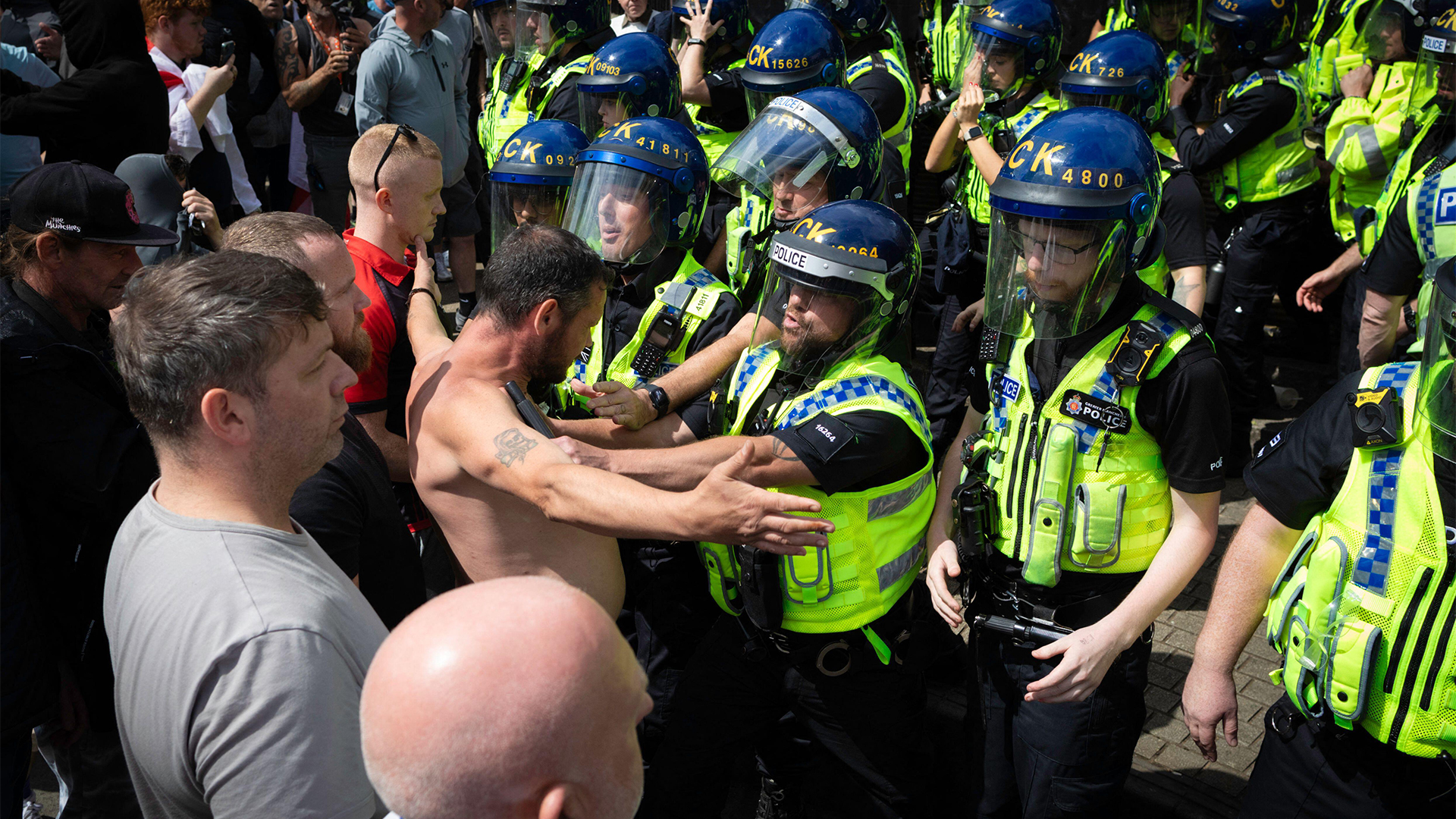 Anti-immigration protesters confront riot police in Manchester in 2024 riots