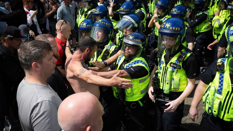 Anti-immigration protesters confront riot police in Manchester in 2024 riots