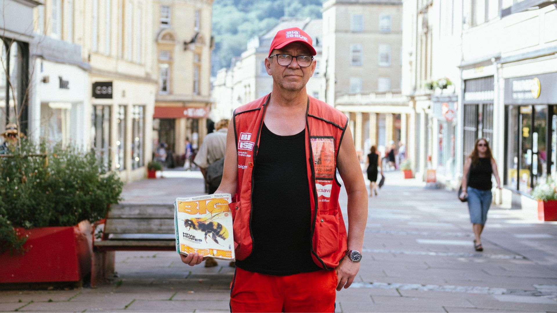 Big Issue vendor Ian Duff stands with a magazine on Union Street in Bath.