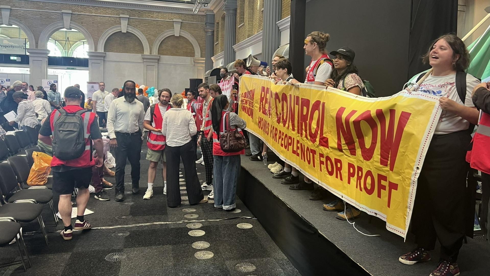 renters from ACORN and London Renters Union storm the stage at the National Landlord Investment Show to demand rent controls