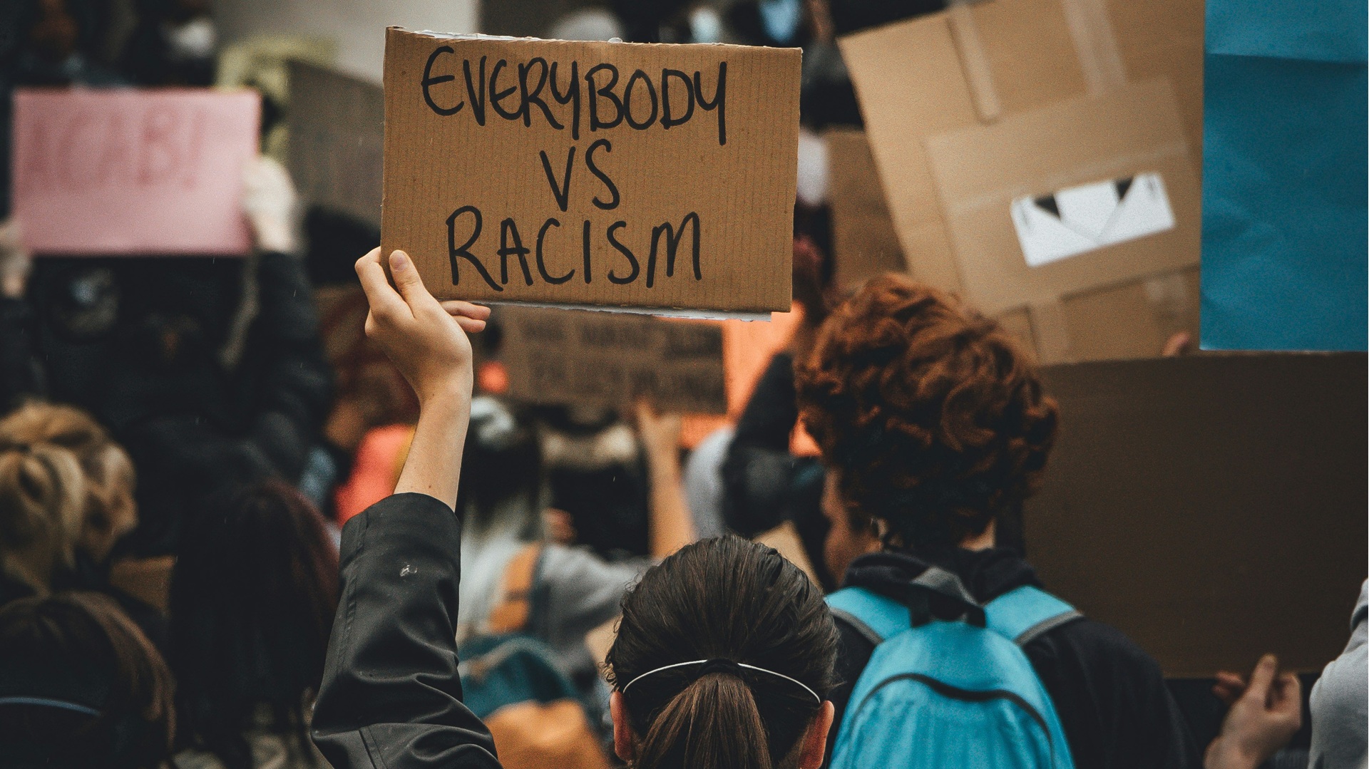 a placard reading: 'everybody vs racism'