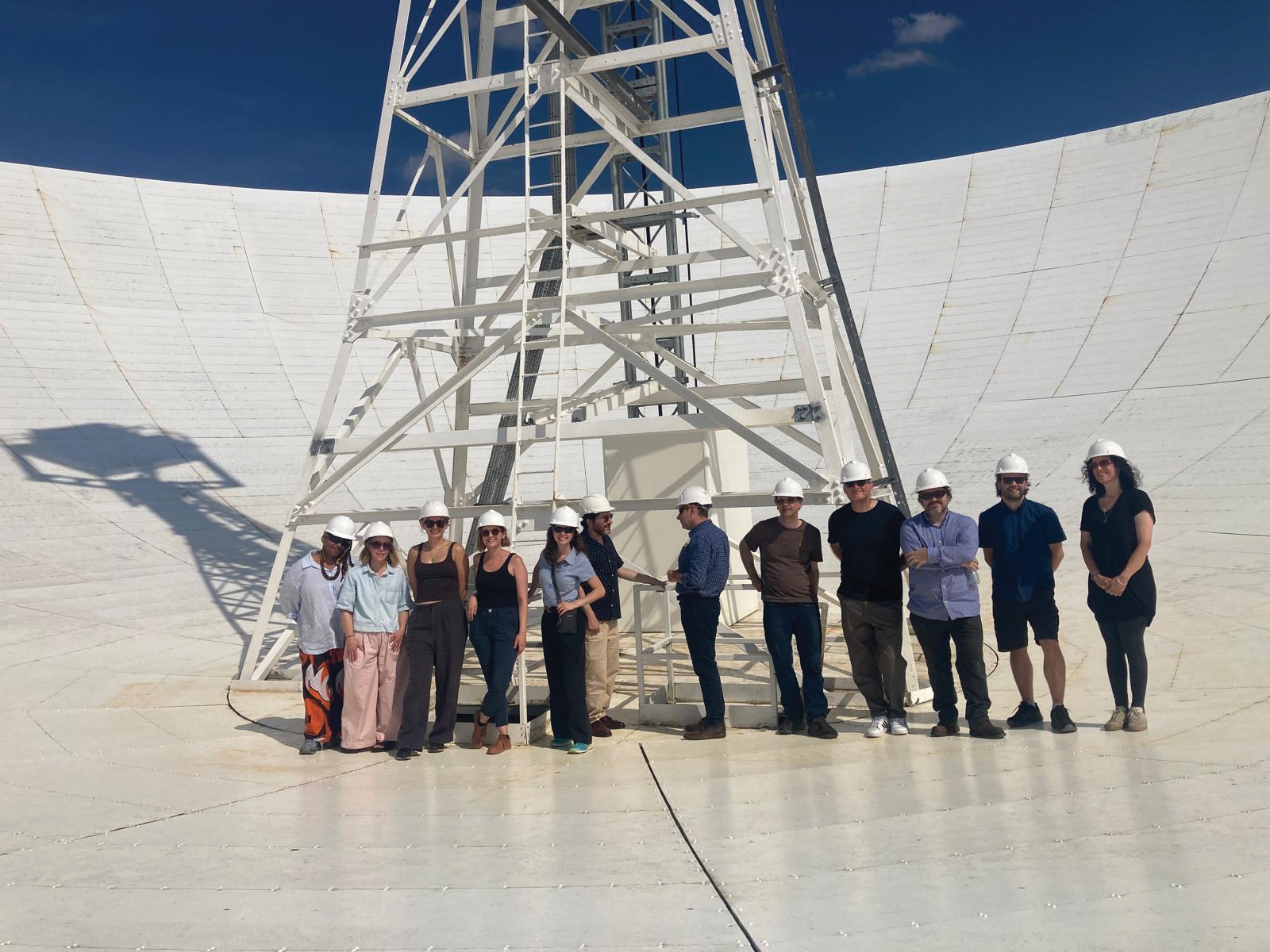 Bront&euml; Schiltz (fourth from left) and the tour group take a walk on the Lovell telescope's surface at Jodrell Bank