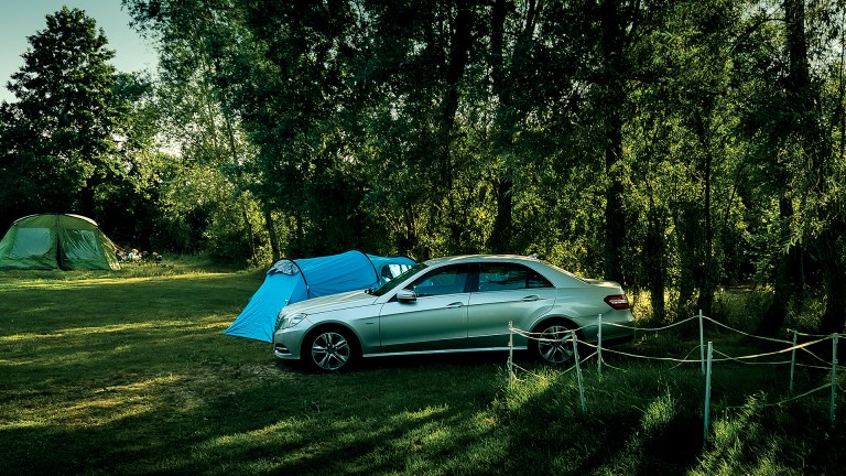 Sam Singleton's car parked next to a tent in the shade