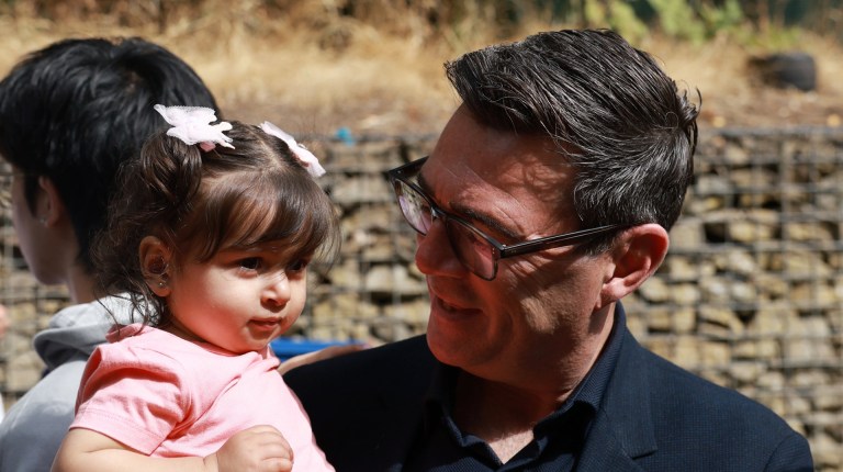 Prime minister Andy Burnham pictured with a child in Sheffield