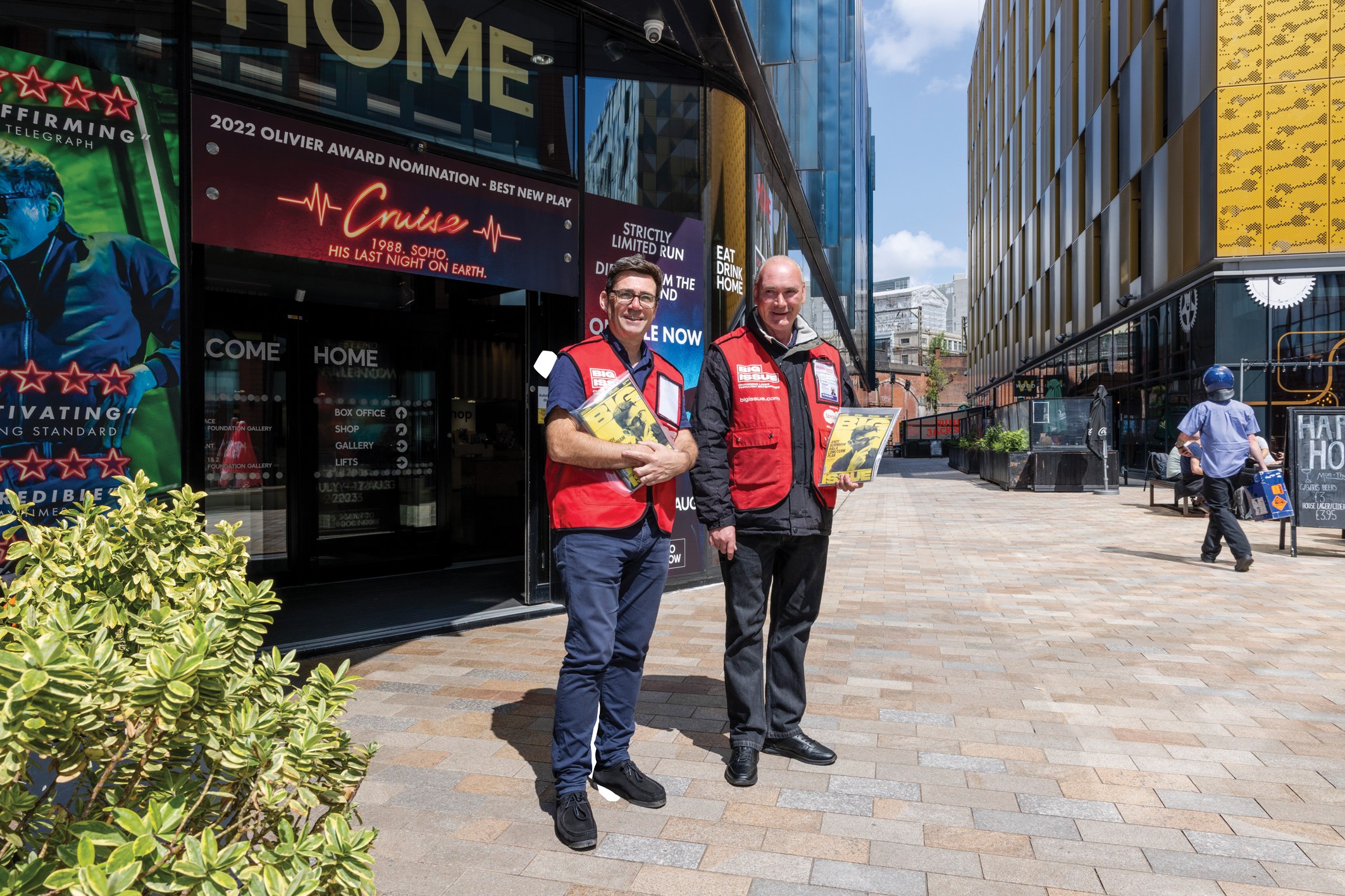Andy Burnham joins his regular Big Issue vendor Colin outside HOME in Manchester in 2023