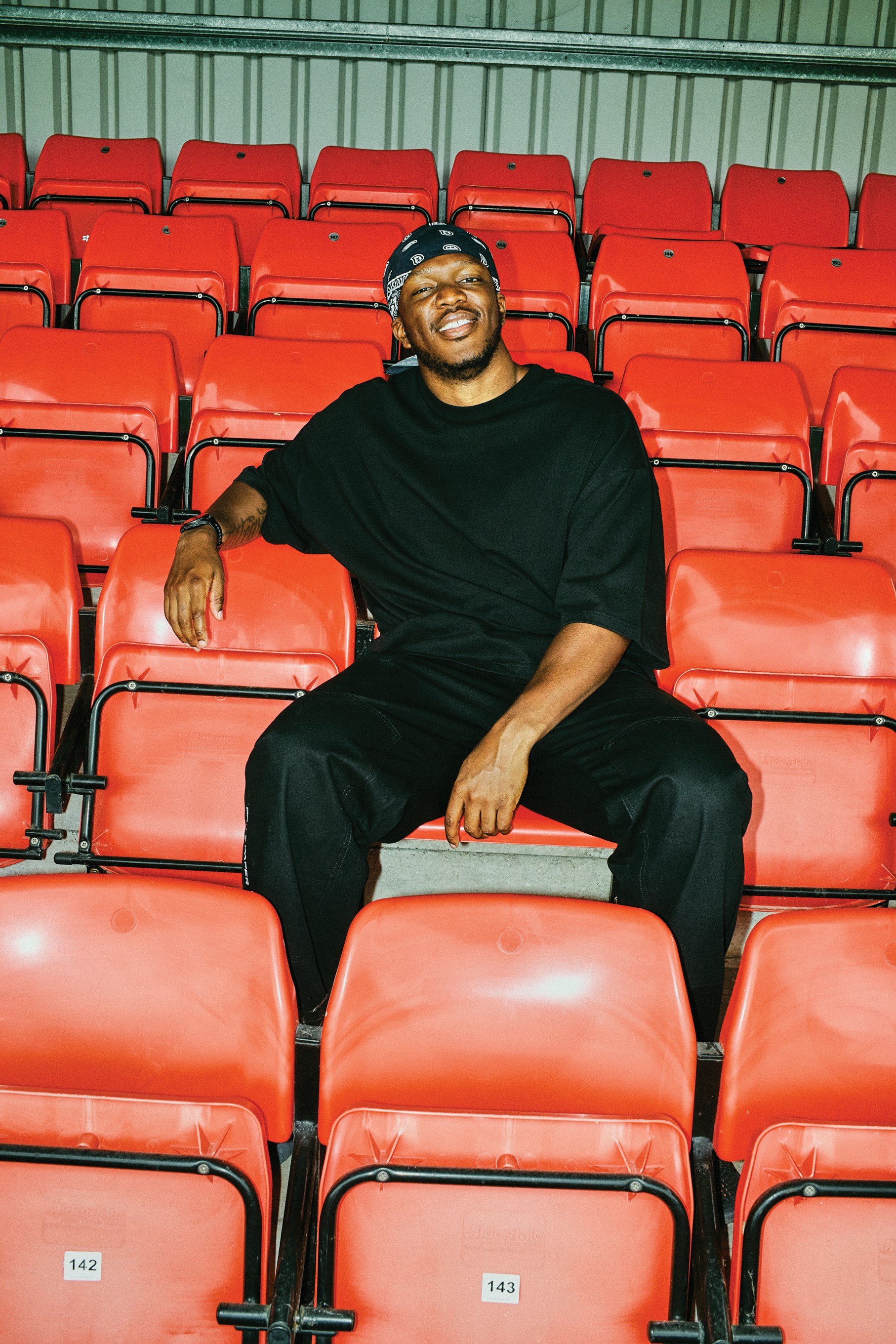 KSI sat in a football stadium stand