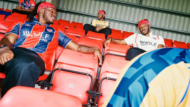 multiple versions of content creator KSI sat in a football stadium stand