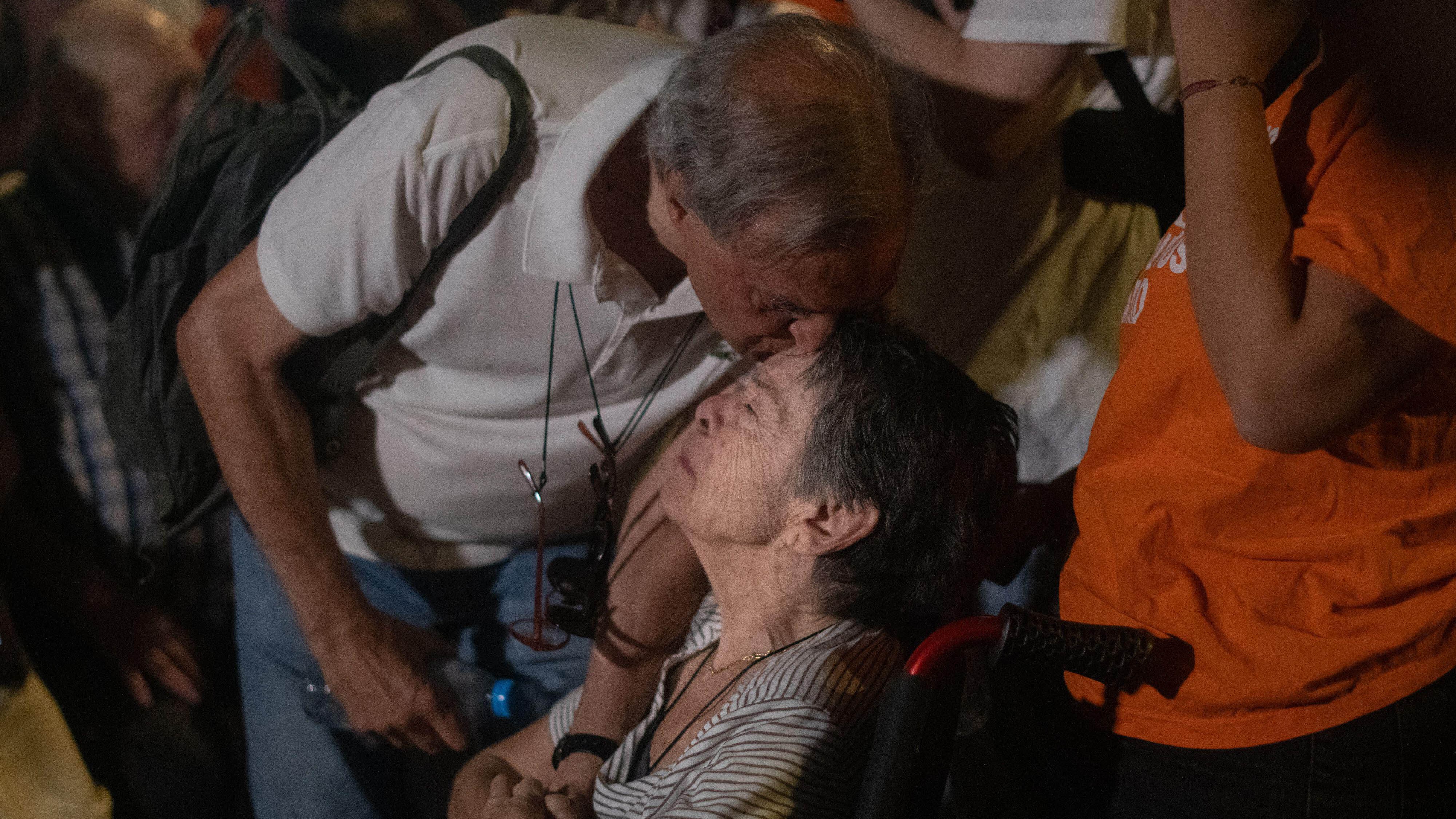 87-year-old Maricarmen is kissed on the head by a supporter as she faces an eviction