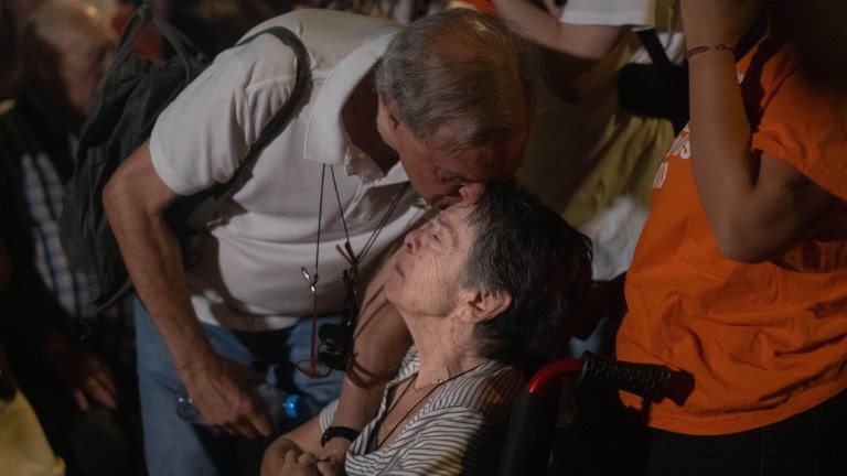 87-year-old Maricarmen is kissed on the head by a supporter as she faces an eviction