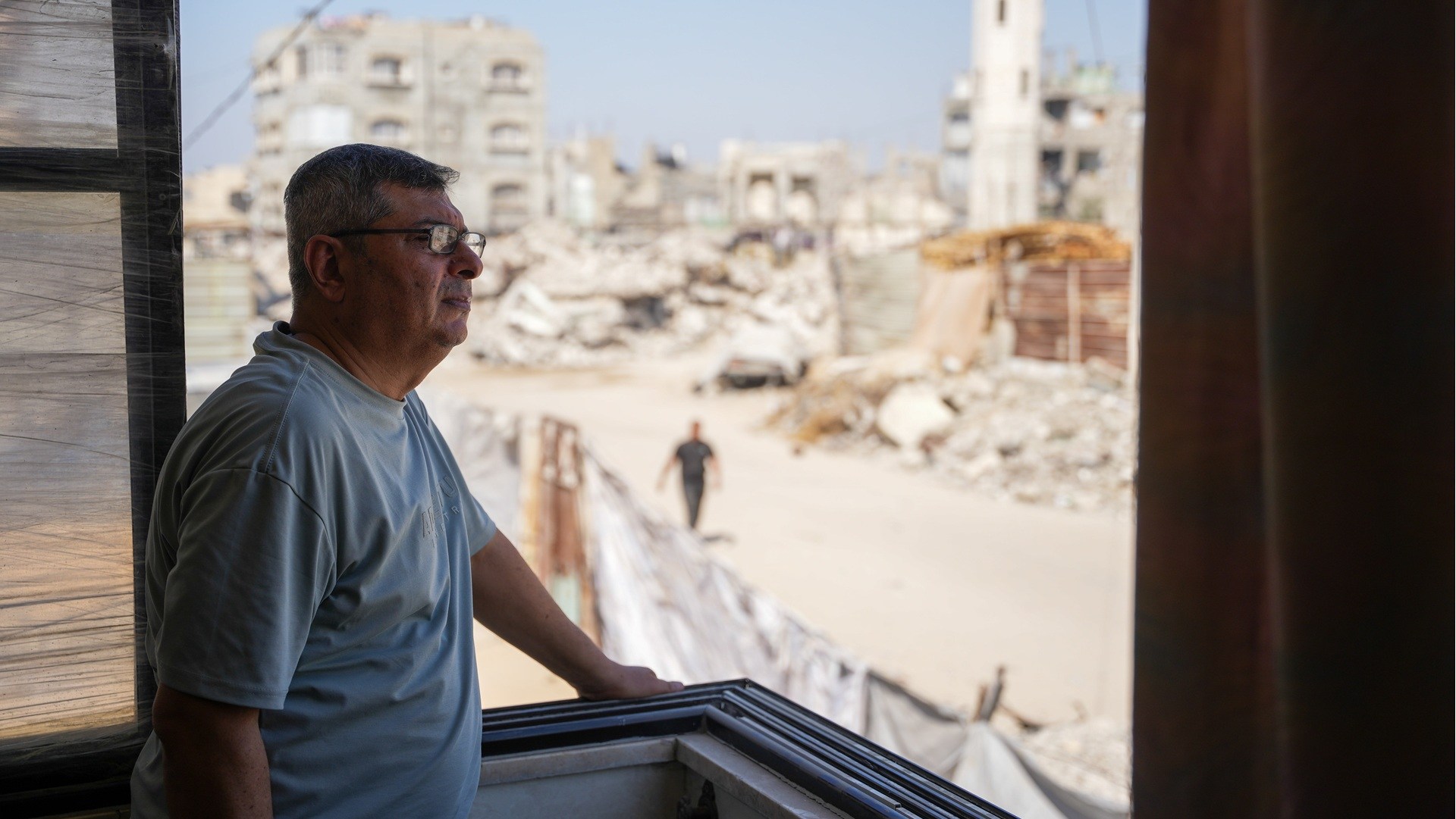 Aid worker Anwar looks out at the ruins of Gaza