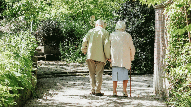 Pensioners with one walking with a walking stick