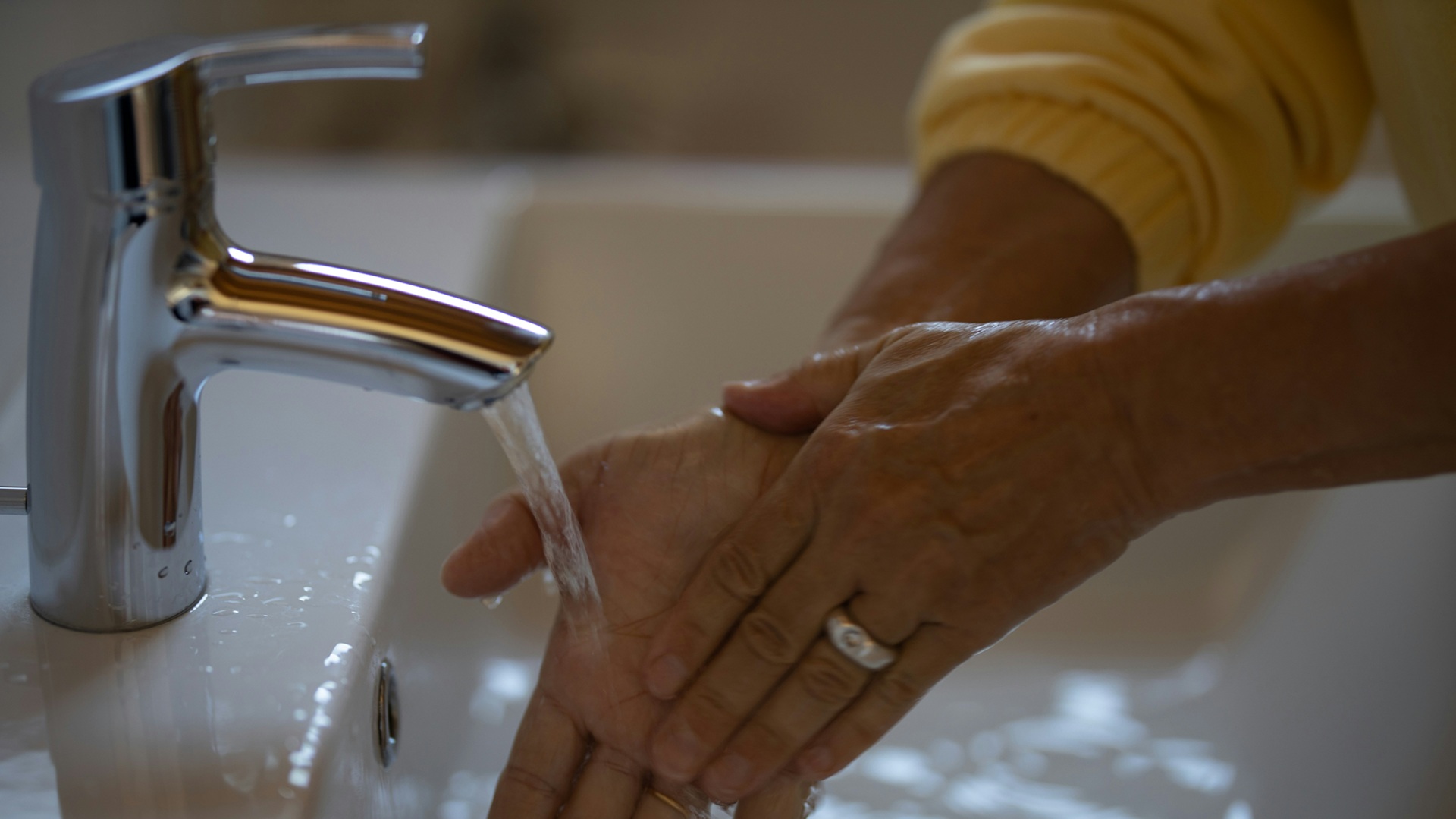 a person washing their hands with water