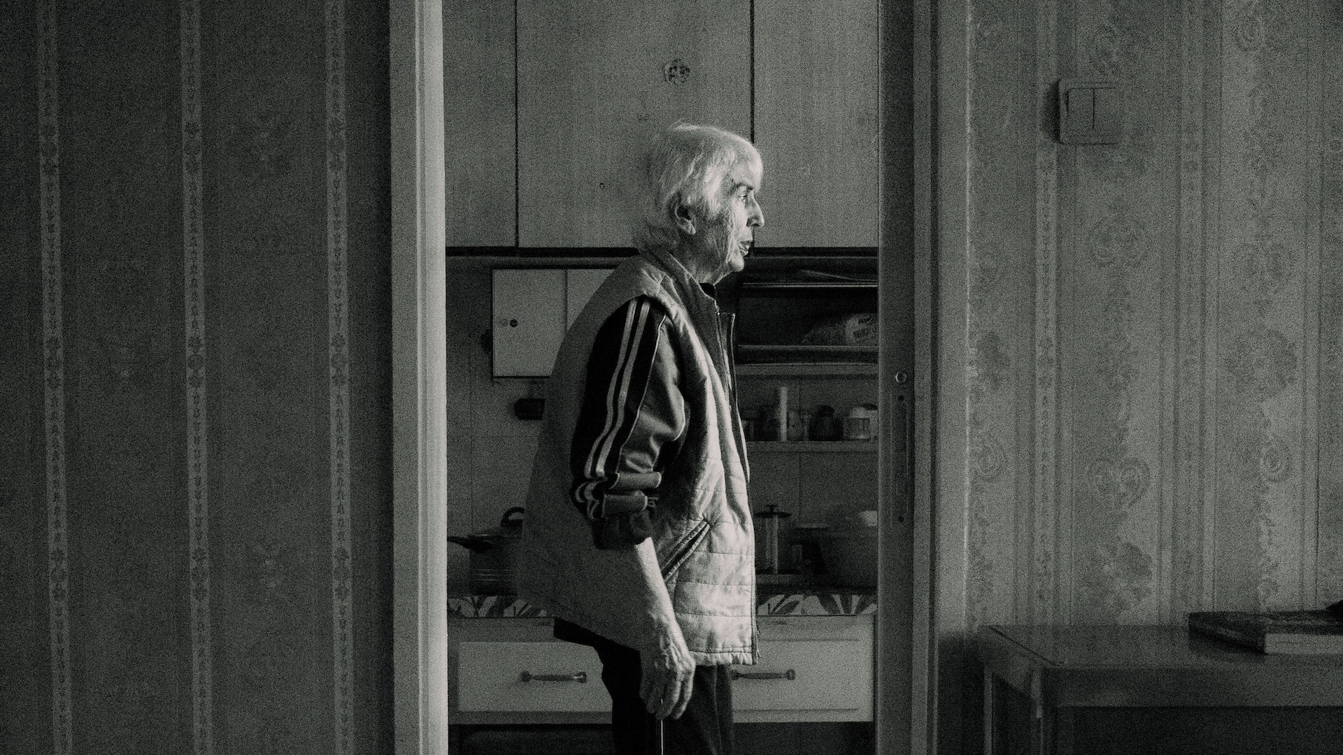 an elderly person looking out