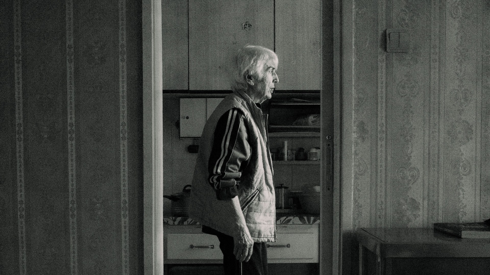 an elderly person looking out