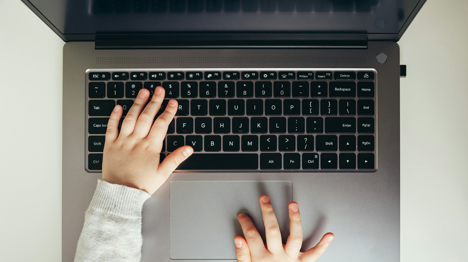 A child's hands on a laptop